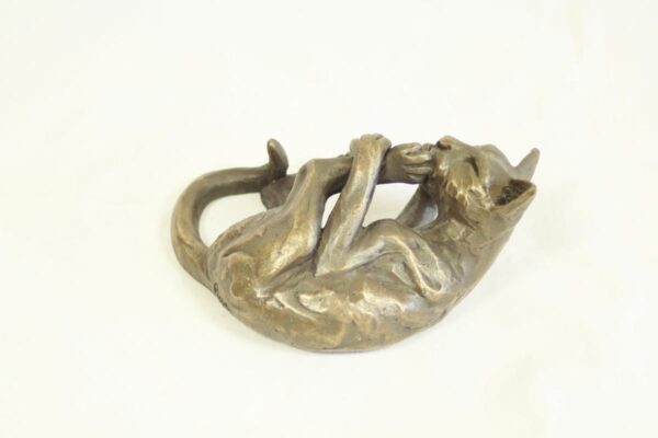 bronze resin Cat lying licking its foot