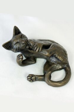bronze resin Cat lying licking its foot